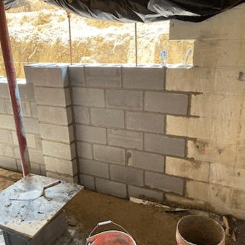 Install new block wall foundation. Grout and rebar cores per code.